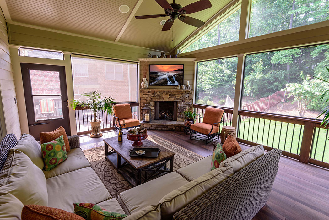 Make the seasons last longer with a screened porch created by Atlanta Design & Build that includes a fireplace and TV. The perfect for entertaining.