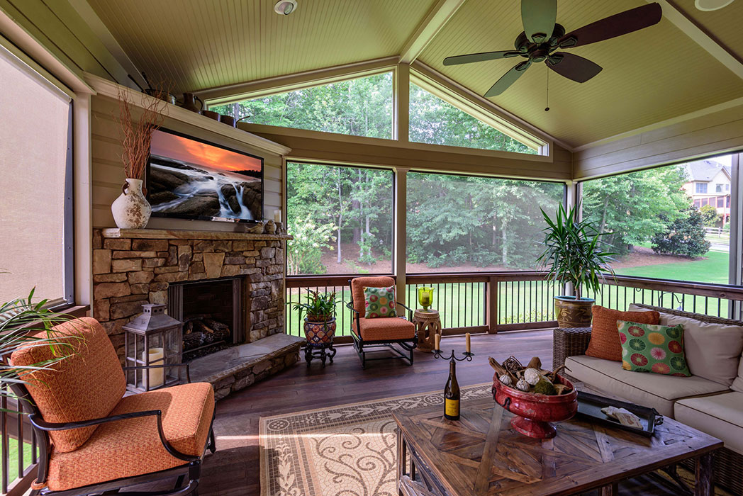 Screened porch with fireplace and TV